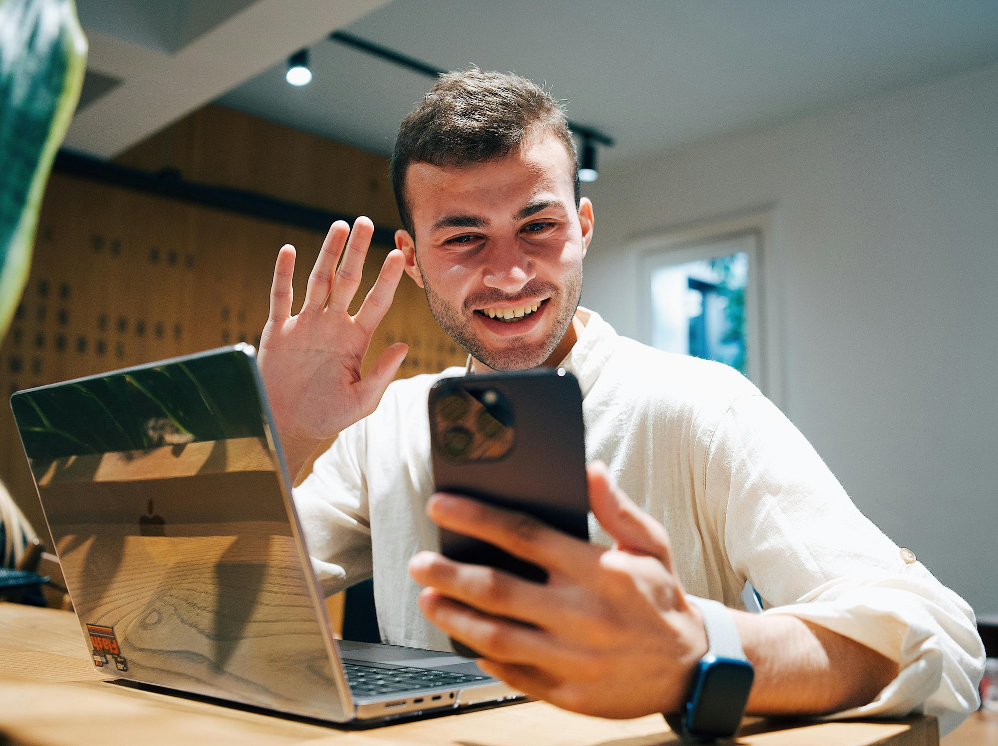 man waving while recording an interactive Hintible video journey